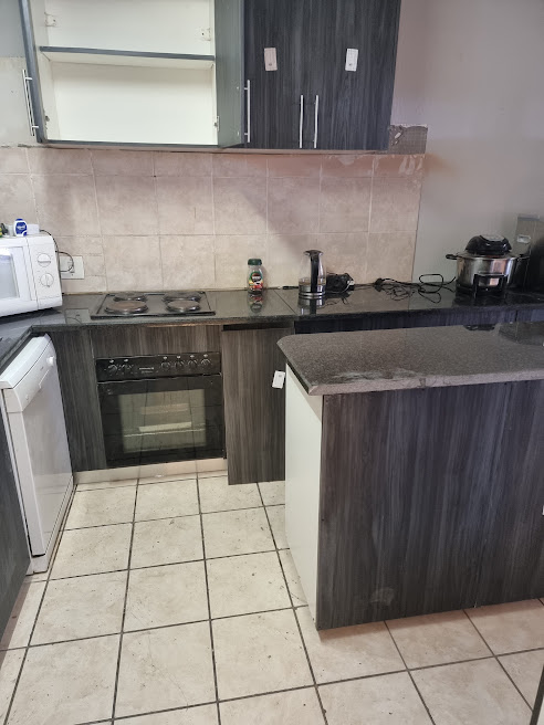 Completed kitchen fitting with tiled floor